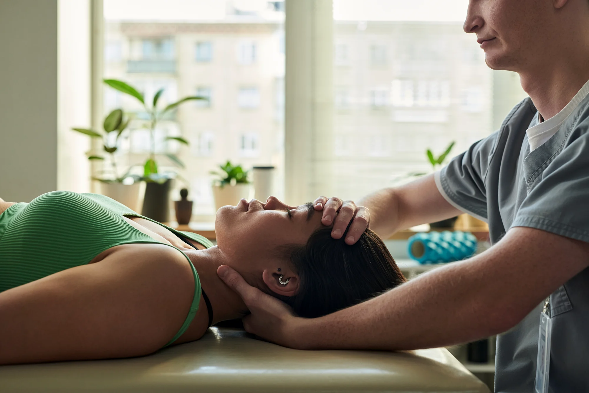 Physical therapist performing manual neck therapy